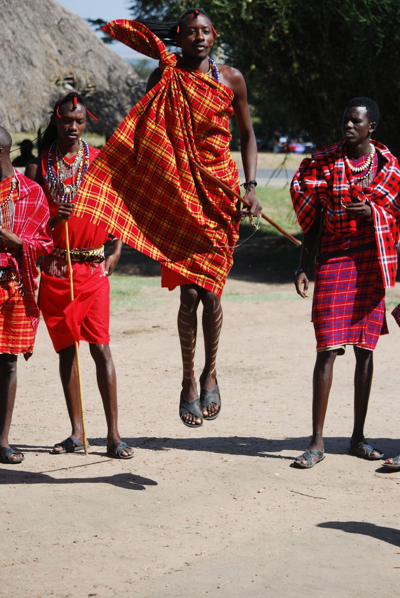 Maasai men performing a traditional jumping dance in a village near Maasai Mara, Kenya.