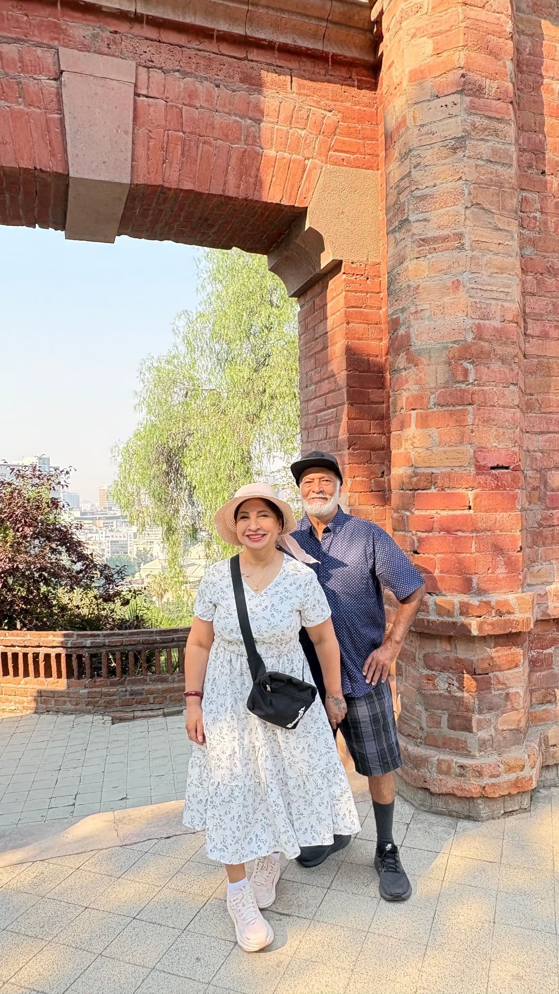 Brick arch at Cerro Santa Lucía with a couple posing beneath it overlooking Santiago, Chile