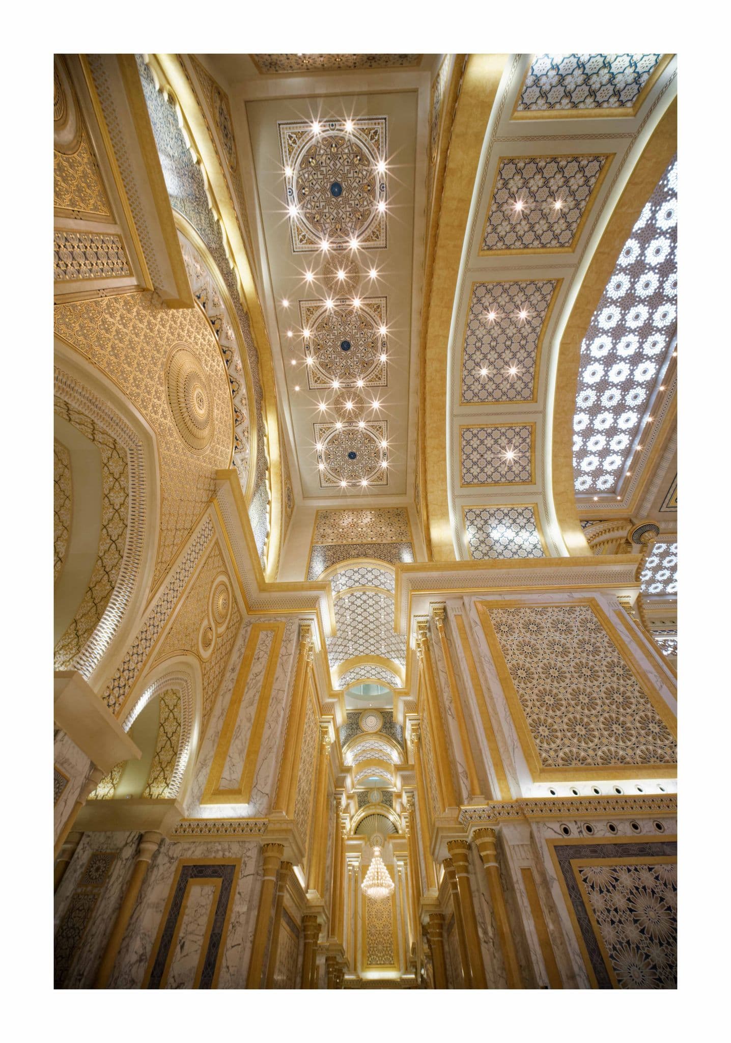 Ornate gilded ceiling, arches and marble columns inside Qasr Al-Watan, Abu Dhabi, United Arab Emirates.