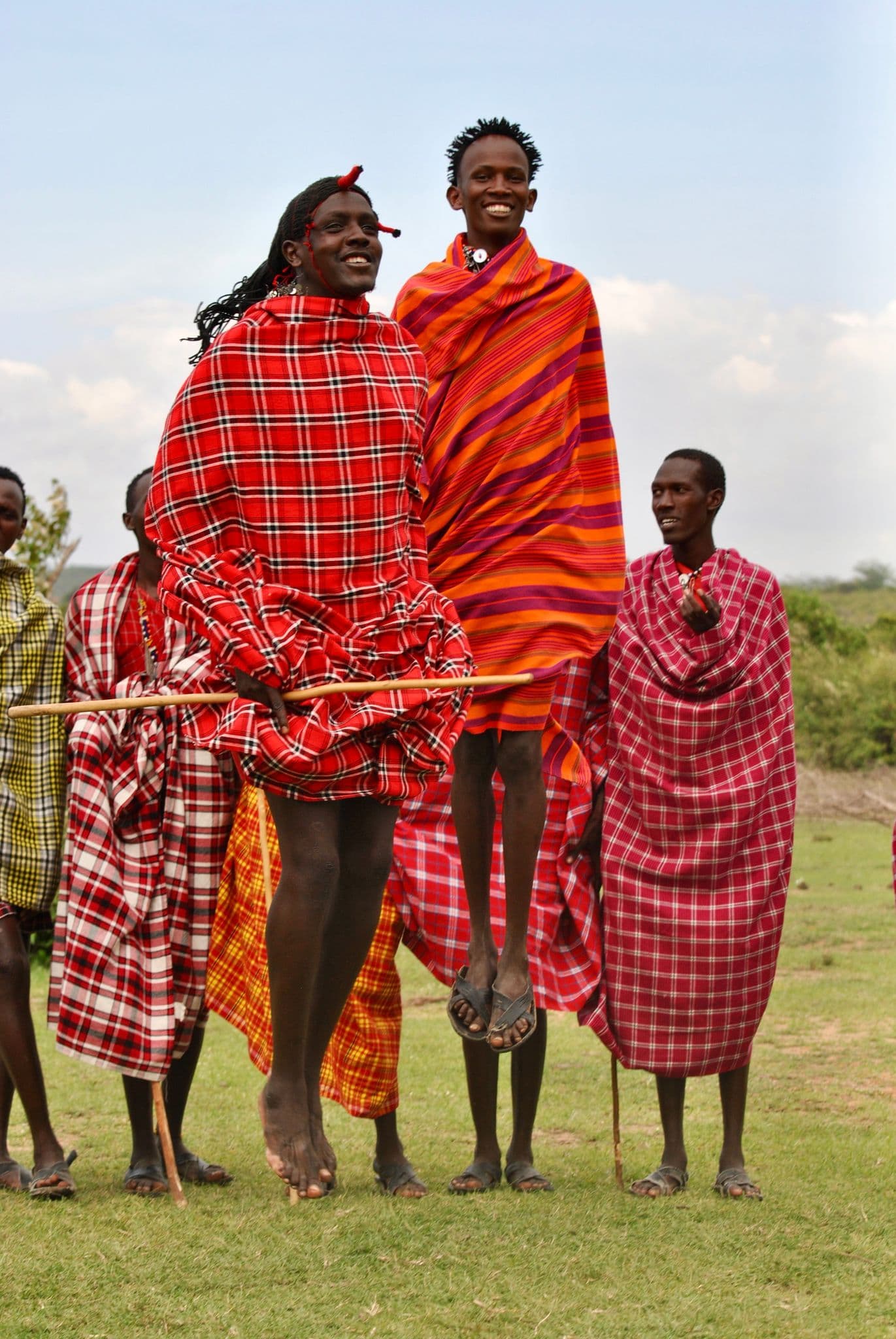 Maasai men performing a traditional jumping dance in a village near Maasai Mara, Kenya.