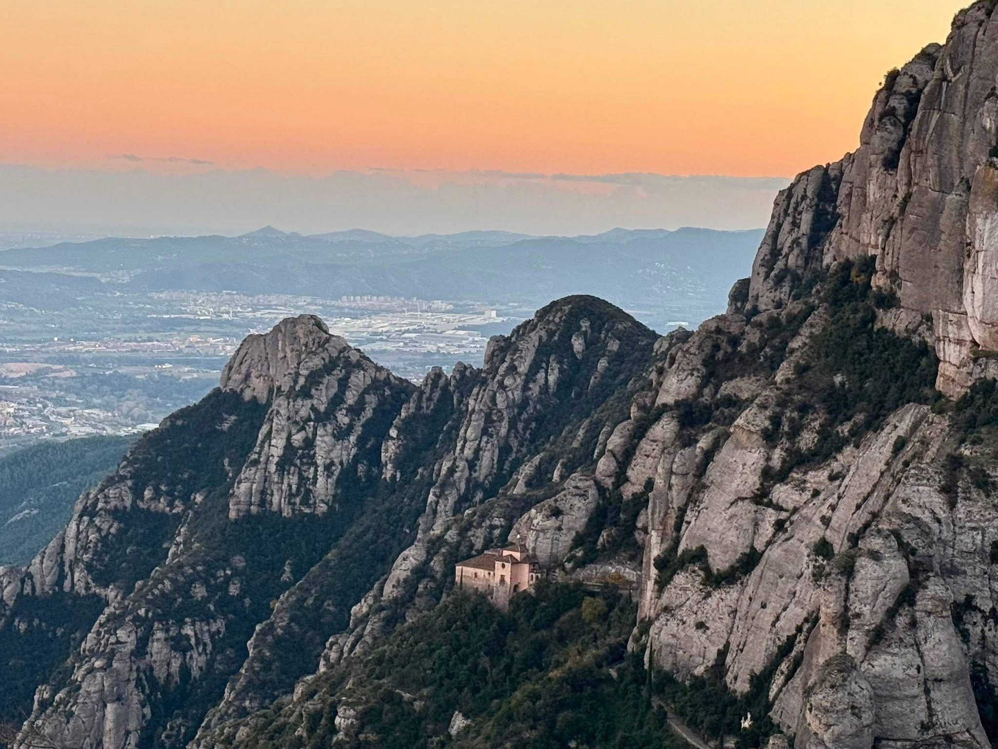 Montserrat mountain and Santa Maria de Montserrat monastery perched on rugged cliffs near Barcelona, Spain.