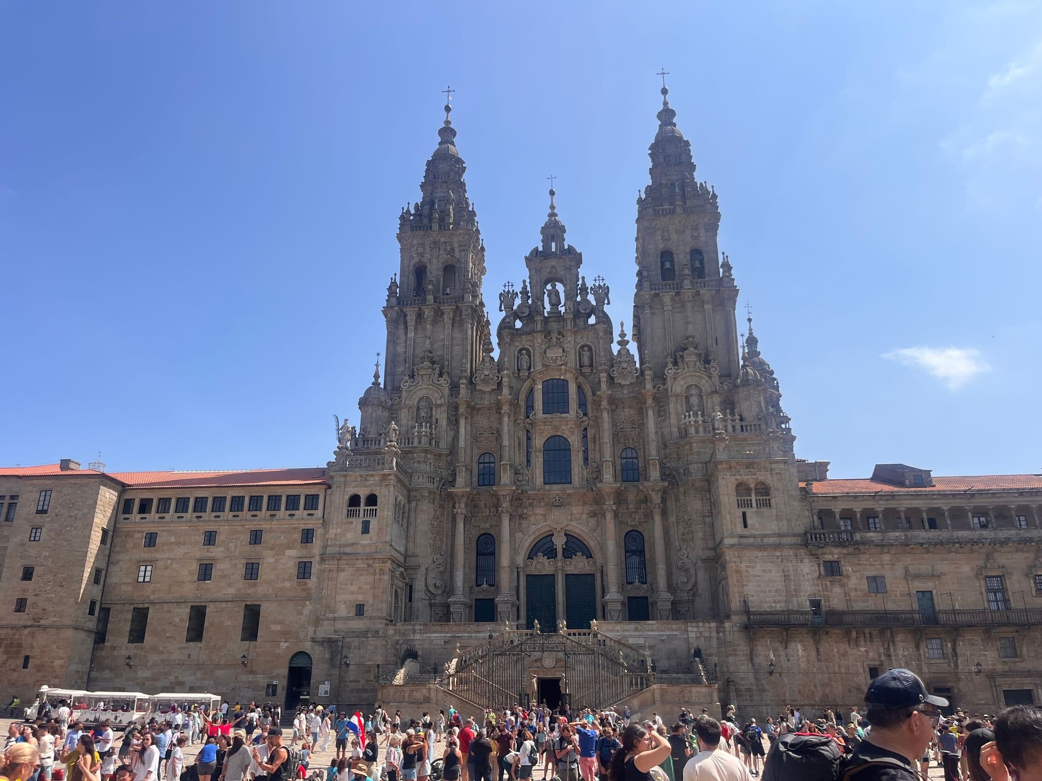 Santiago de Compostela Cathedral centered with crowds gathered in the front plaza, Santiago de Compostela, Spain.