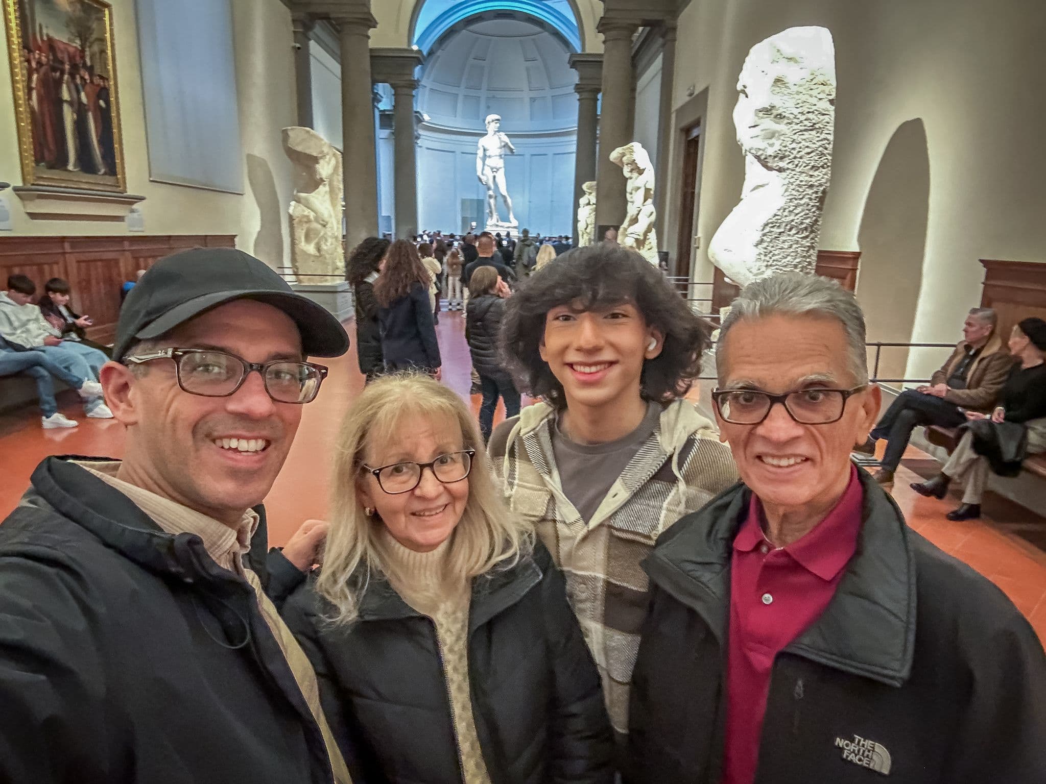 Michelangelo's David at the Galleria dell'Accademia with an immediate family taking a selfie in Florence, Italy