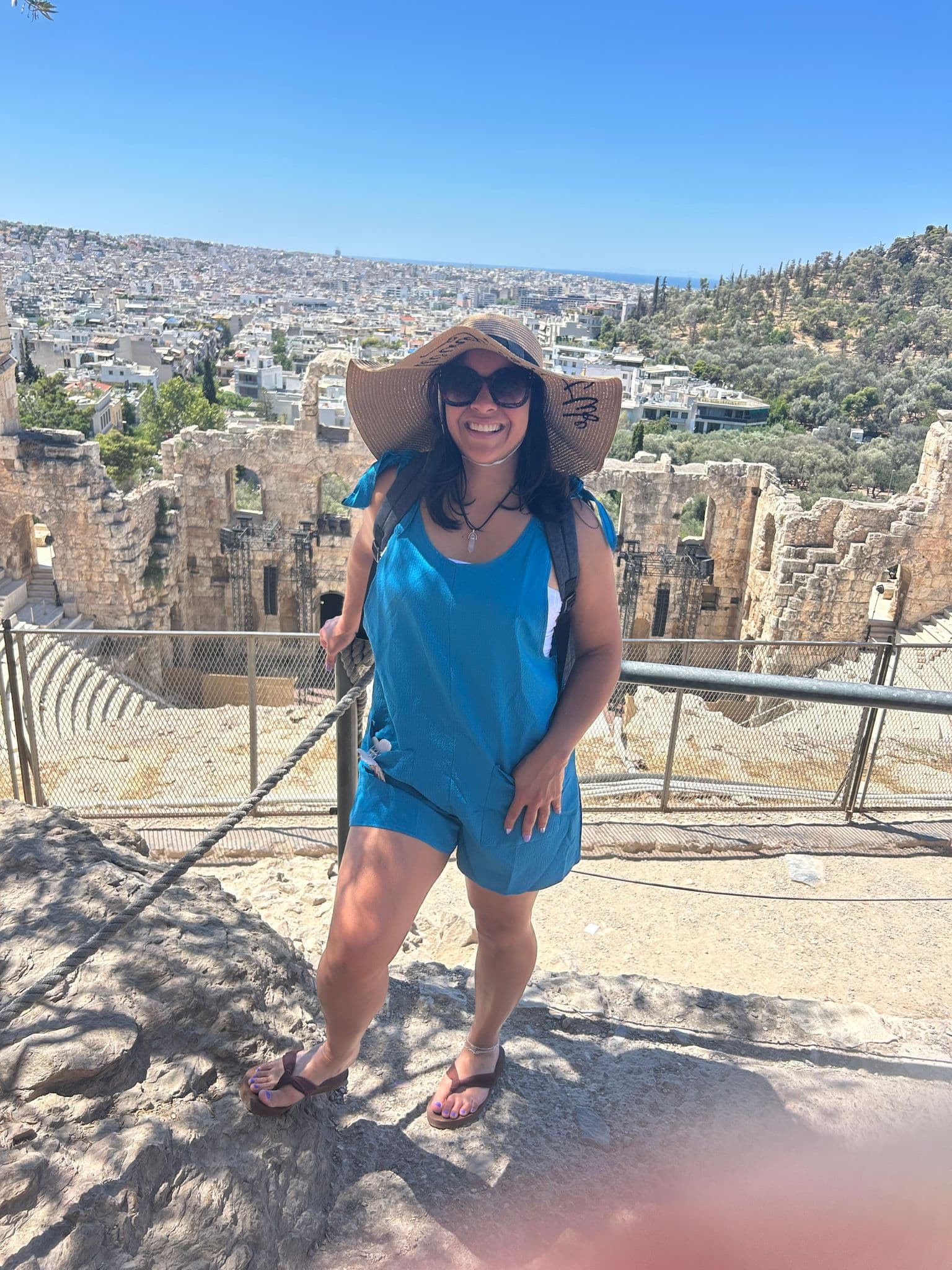 Odeon of Herodes Atticus amphitheater with a woman posing on a lookout, Athens, Greece.