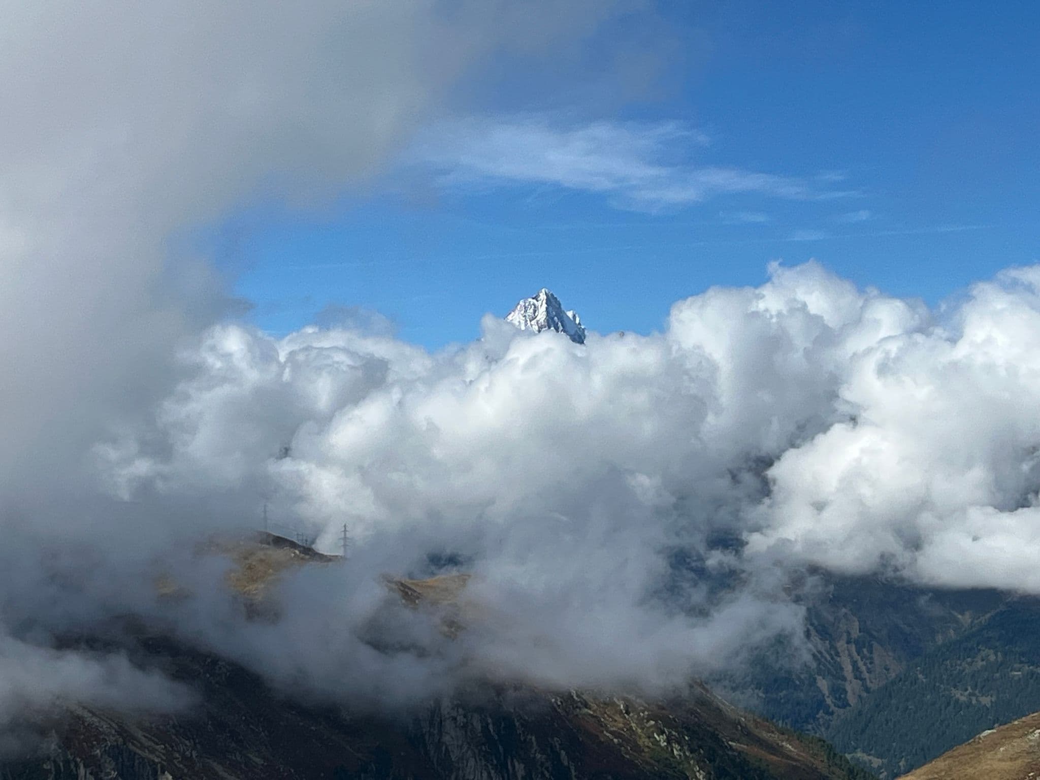 Matterhorn peak rising above thick clouds near Zermatt, Switzerland.