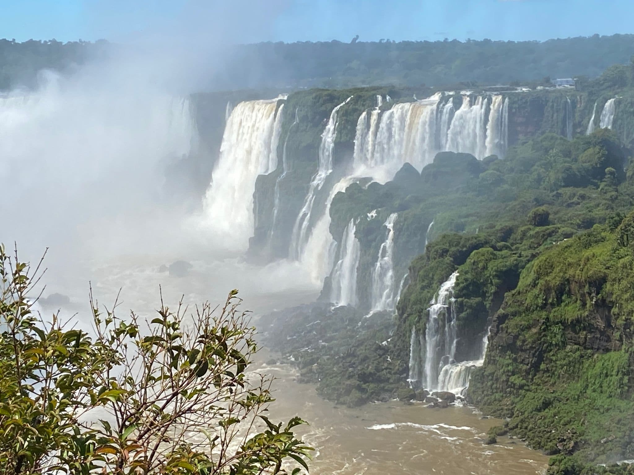 Iguazu Falls cascading over multiple cliffs into the Iguazu River, view from the park in Misiones, Argentina.