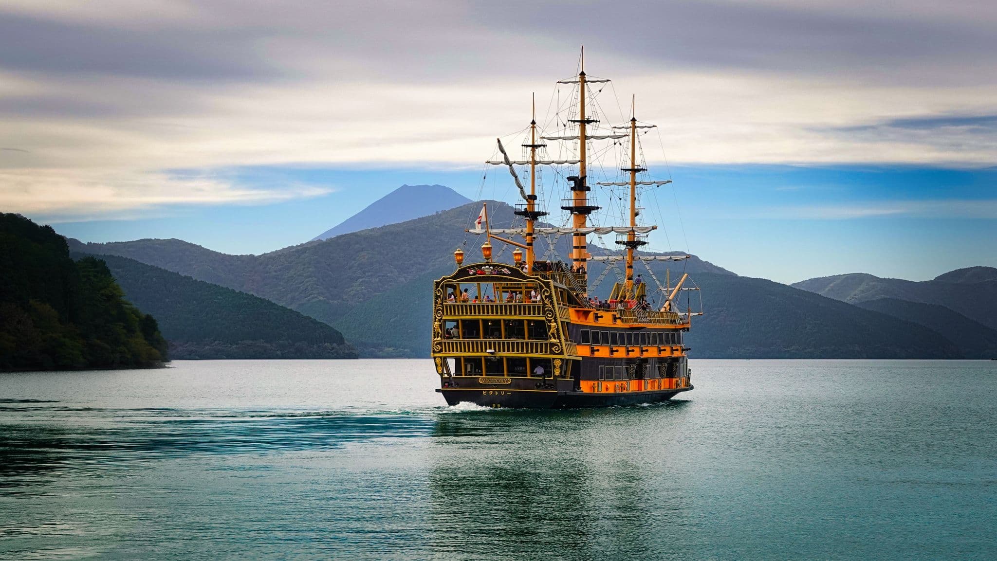 Mount Fuji framed behind a three-masted sightseeing ship on Lake Ashinoko in Hakone, Japan.