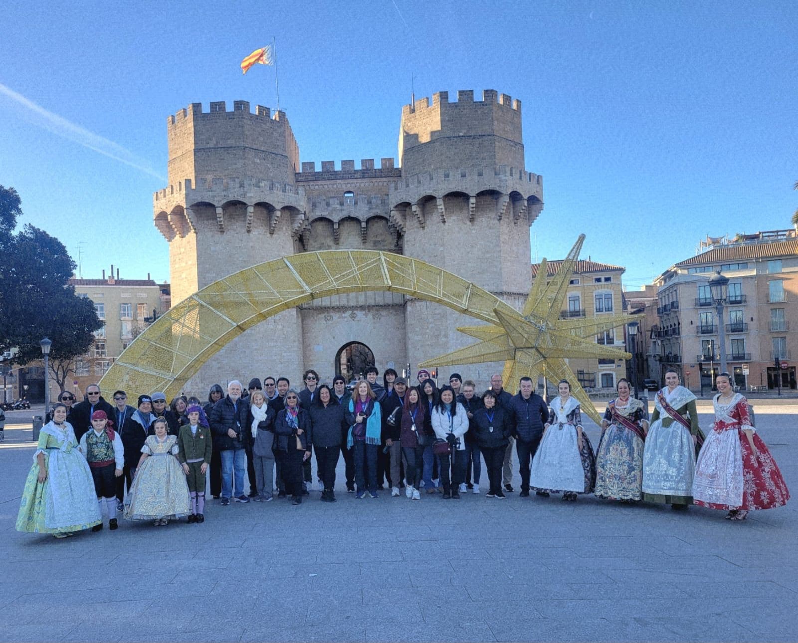 Serranos Towers in Valencia with a large group posing in front of a decorative arch and star, Valencia, Spain