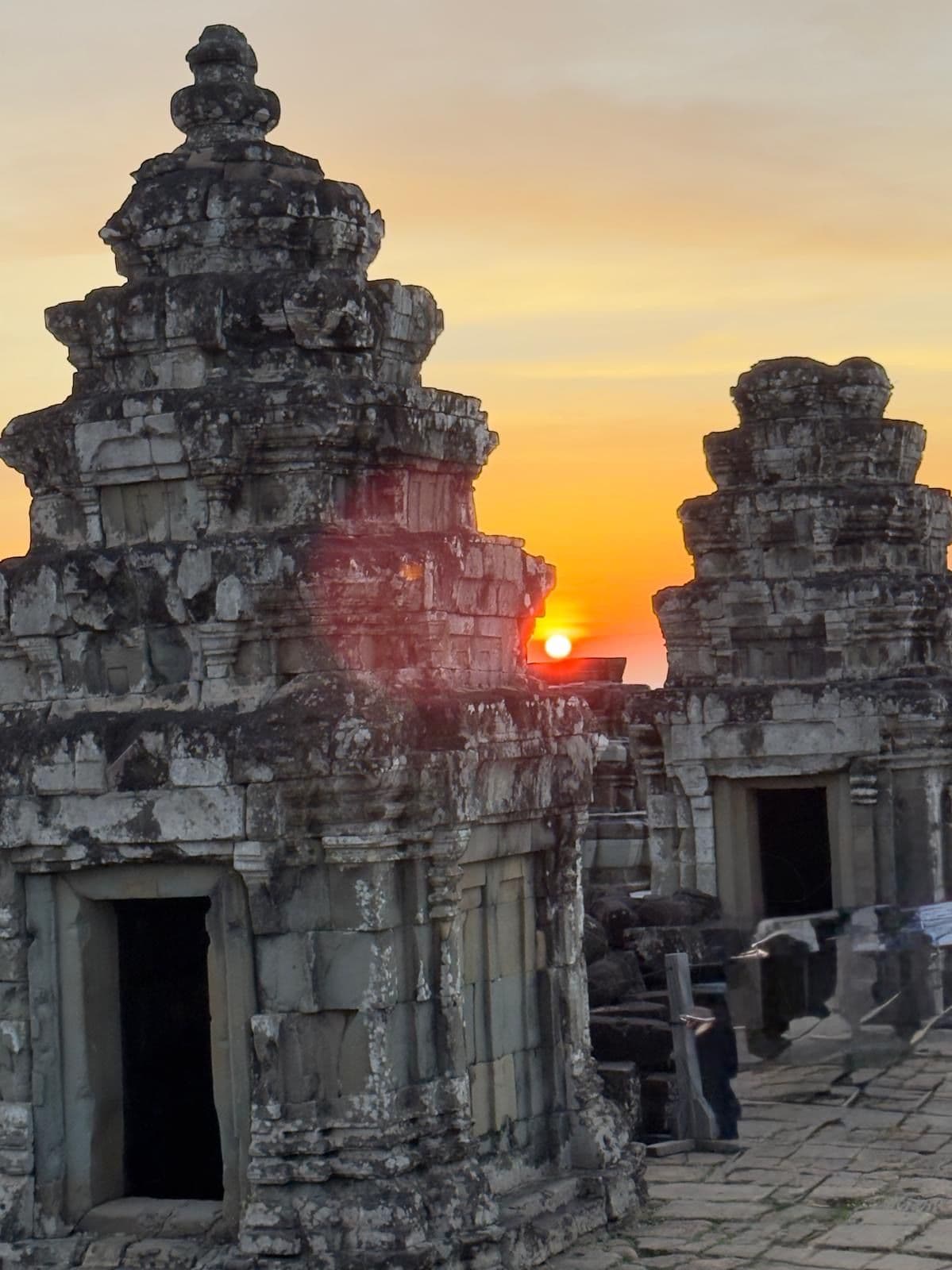 Angkor Wat temple towers framing the sunrise over the stone ruins in Siem Reap, Cambodia.